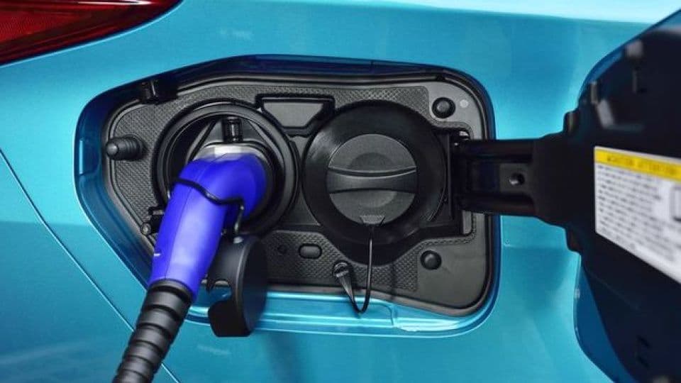 Mavi bir elektrikli araç şarj istasyonunda şarj oluyor.