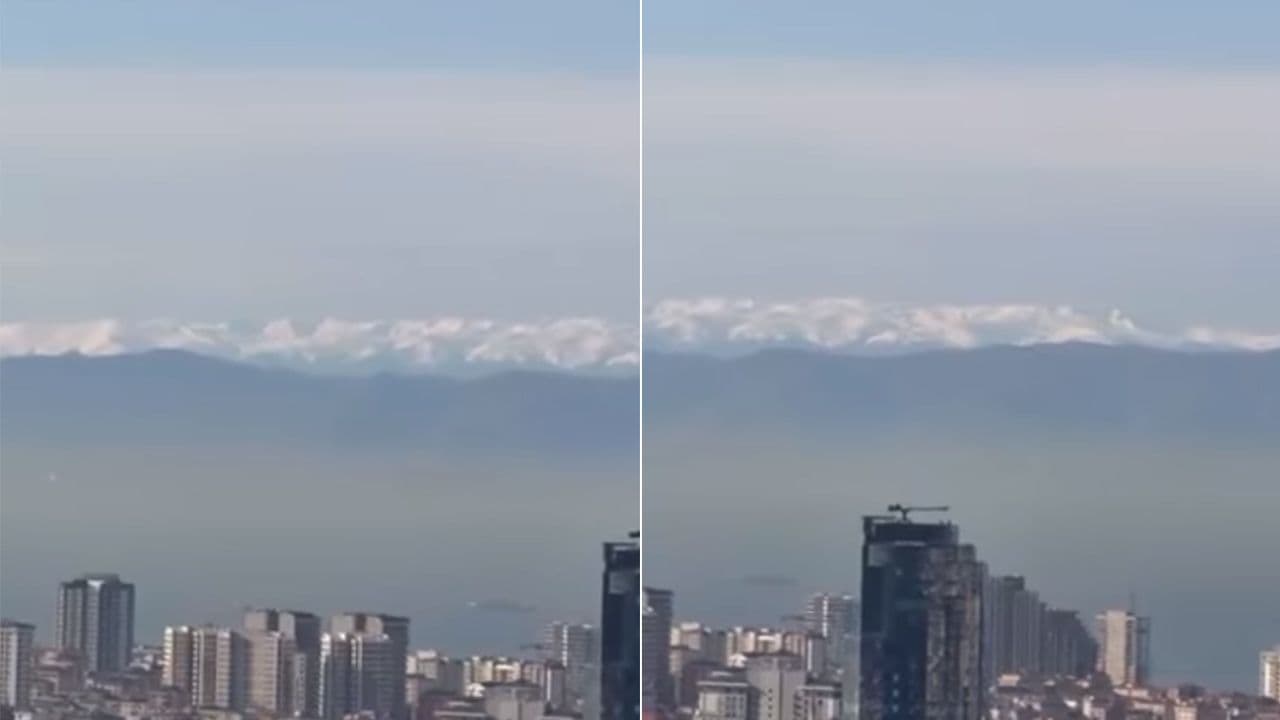 İstanbul şehir silüetinin arkasında uzanan Uludağ'ın karlı zirveleri.