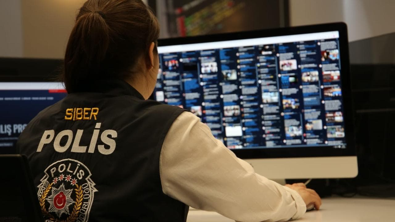 Siber polis memuru bilgisayar başında, sosyal medya hesaplarını inceliyor.