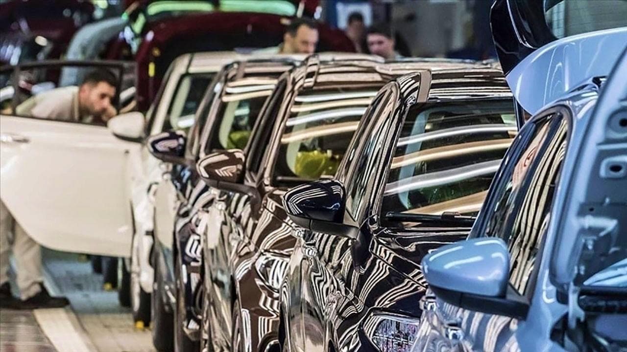 Otomobil üretim hattında çalışan işçiler ve yeni üretilmiş araçlar.