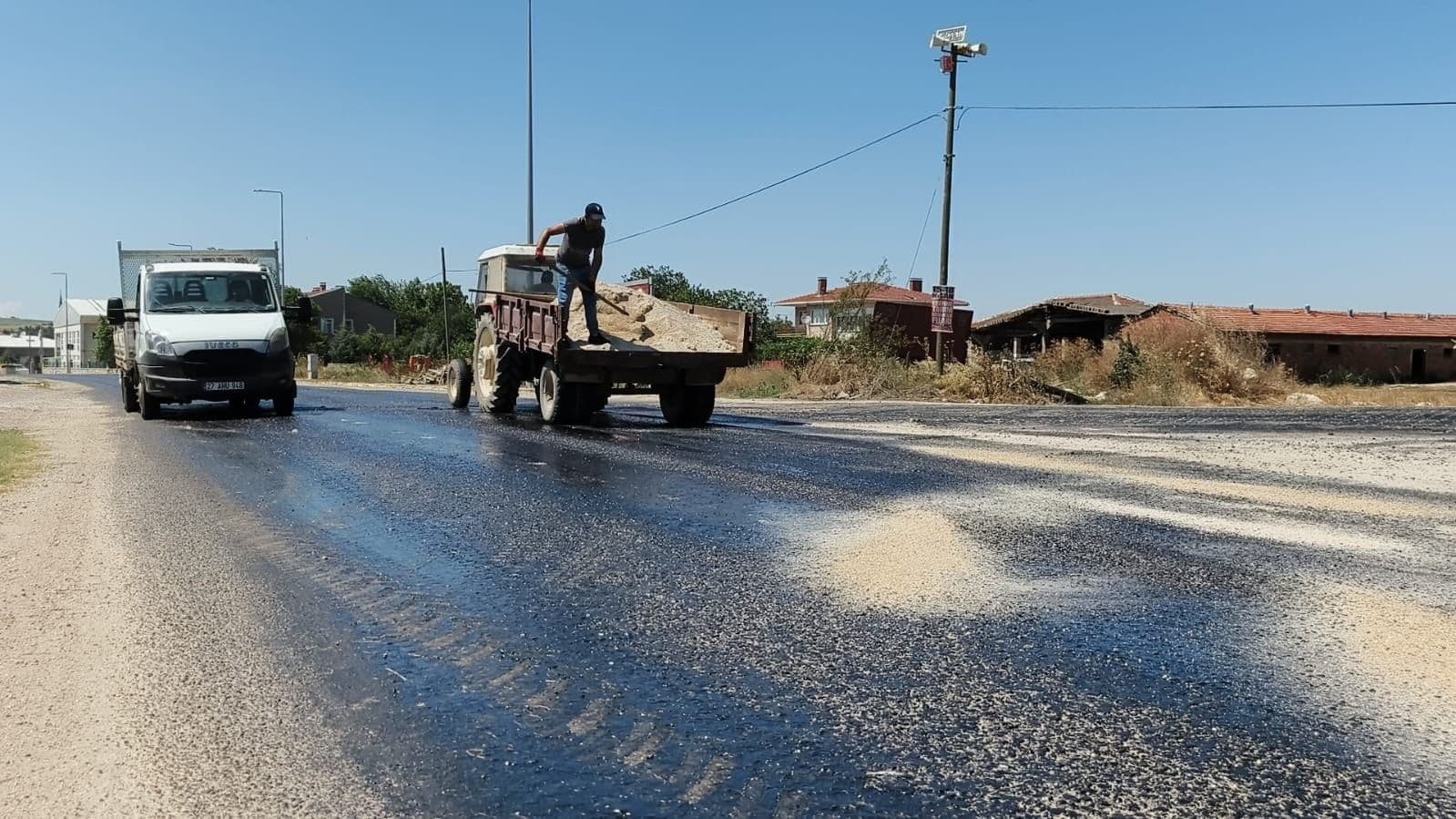 Edirne'de sıcaklar nedeniyle eriyen asfalta kum seren belediye ekipleri.