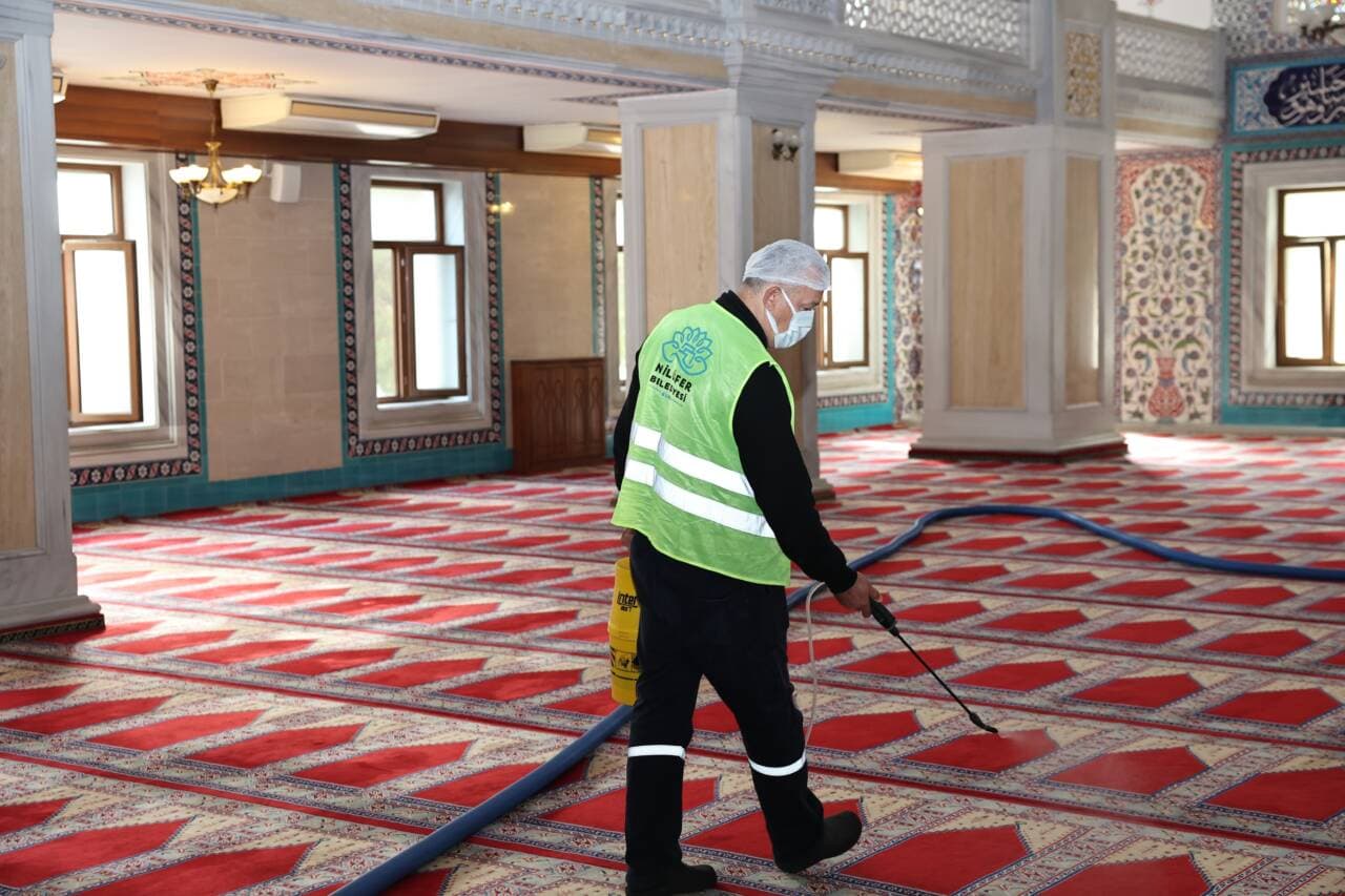 Nilüfer Belediyesi görevlisi, bir caminin halılarını özel ekipmanla temizliyor.