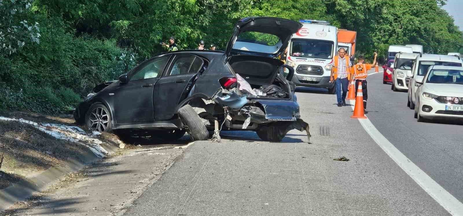 Sakarya TEM Otoyolu'nda meydana gelen trafik kazası sonrası hasar görmüş araç ve olay yerindeki ambulans.
