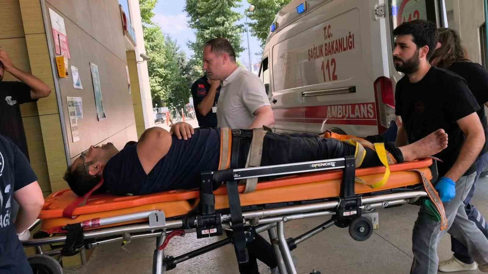 İnegöl'de tekstil fabrikasında iş kazası sonrası sedyede taşınan yaralı işçi ve sağlık ekipleri.