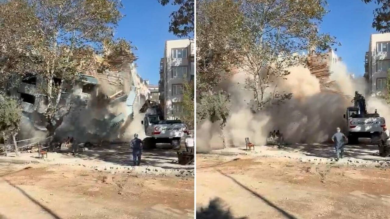 Bursa Mustafakemalpaşa'da yıkım sırasında çöken apartman ve oluşan yoğun toz bulutu.