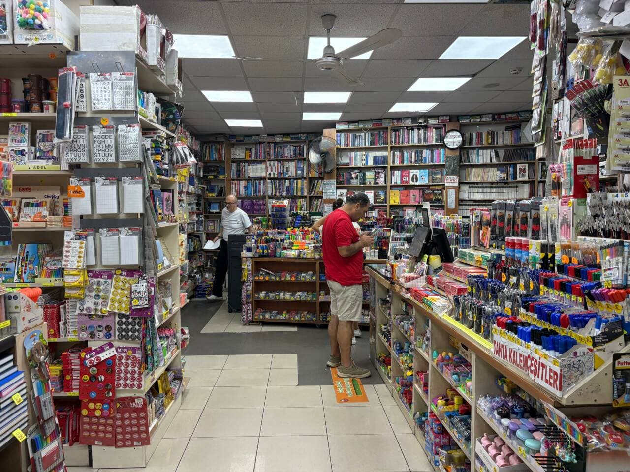 Bursa'da okul alışverişi yapan veliler ve kırtasiye ürünleriyle dolu raflar.